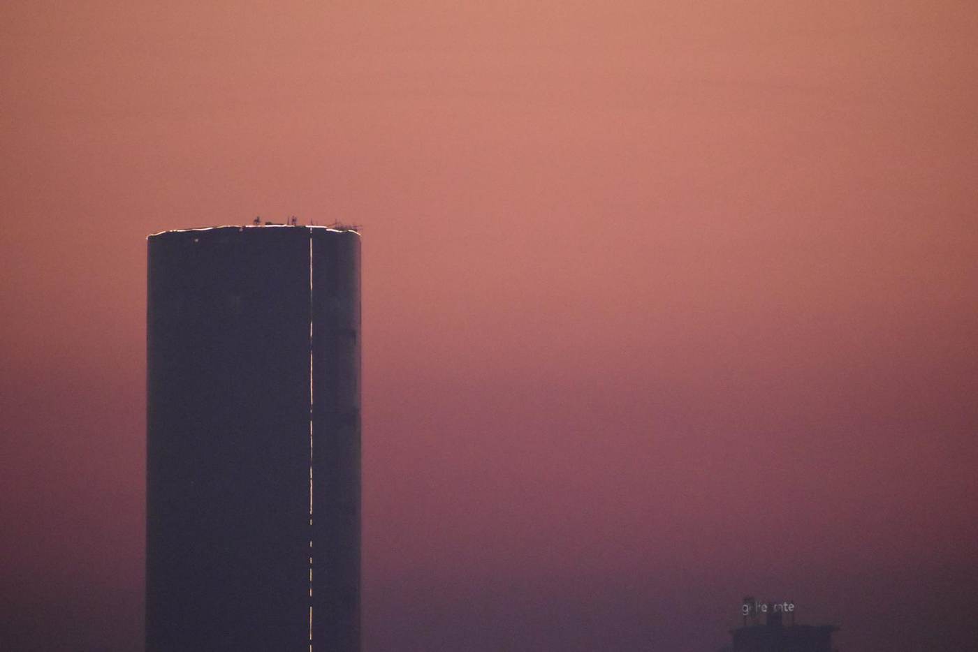 Stock photograph of a tall tower in haze in Gurugram. Not a project for sale.